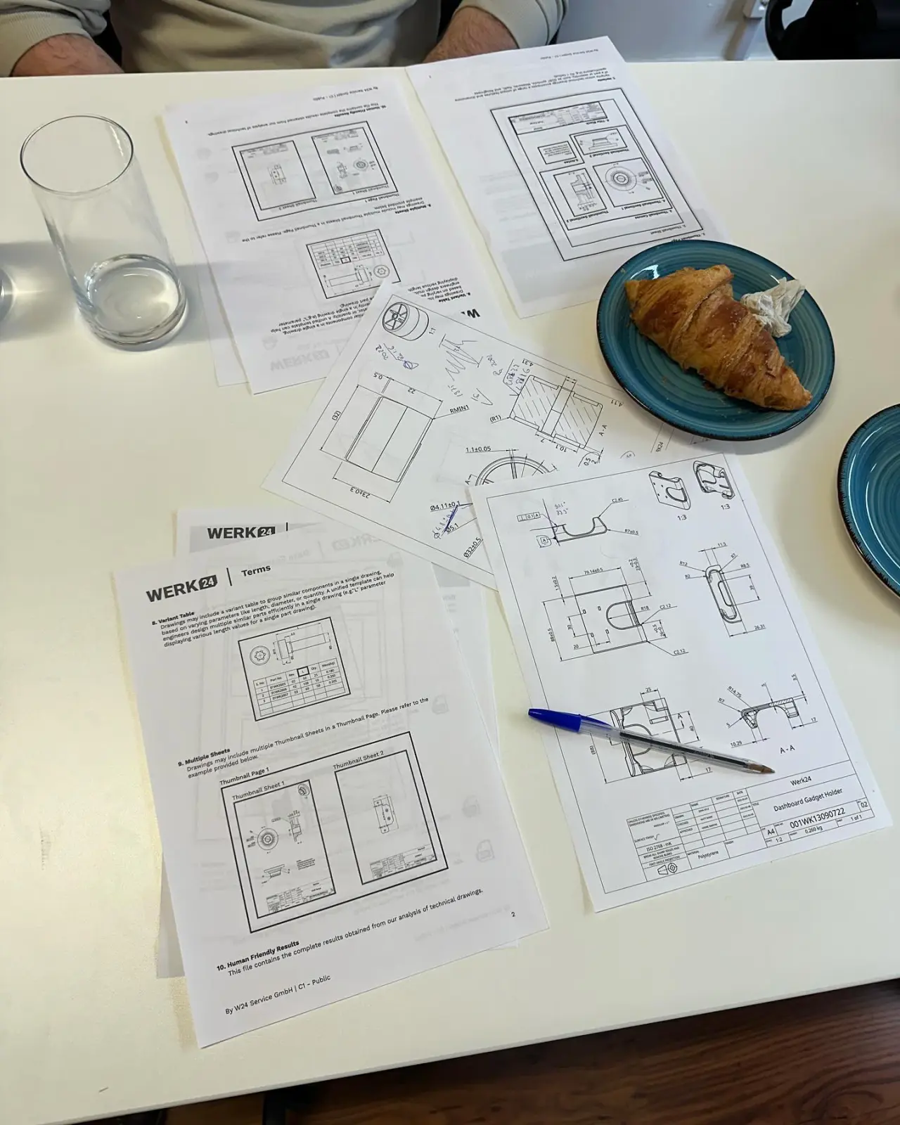 Technical drawings on the table during a client deep-dive